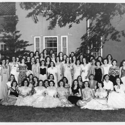 Women in gowns in front of club house