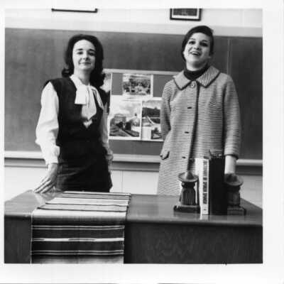 Spanish classroom with 2 teachers or perhaps a student and a teacher circa 1960.