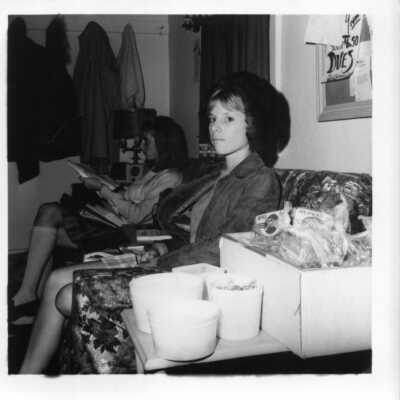 Two students relaxing on a sofa circa 1960.