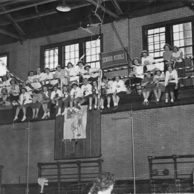 Spectators watch a basketball game (1949-1950)