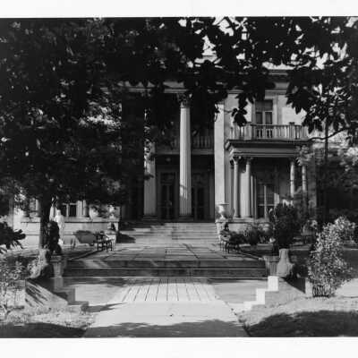 Front steps of Acklen Hall on Ward-Belmont campus.Several benches and planters visible along with a classical statue and four lion statues.