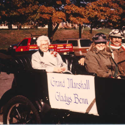 Grand Marshall Gladys Benn being driven by Bill Brigiani and Mary Nelson.