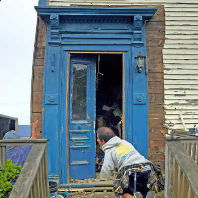 Door and surround being removed and placed in collections of Tides Institute.