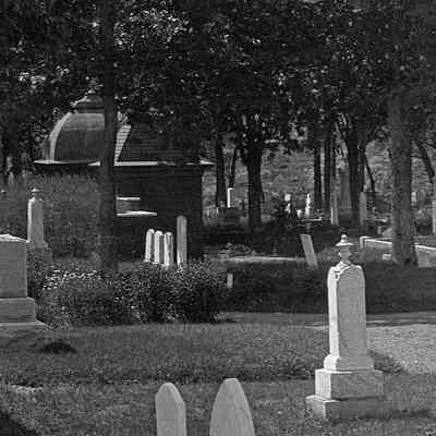 Photograph showing fountain in its original location near the rear of east side of Hillside Cemetery in Eastport, Maine. Masonic Tombs can be seen at the far left of the photograph. Photograph dates to about 1900.