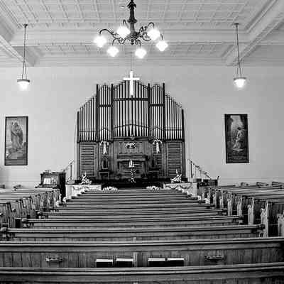 Interior of Washington Street Baptist Church, 2002 before renovations to become Eastport Arts Center performance space. Two c.1900 glass mosaic religious themed panels can be seen on either side of the H.C. Harrison tracker organ. The panel on the left was designed and created by Tiffany Studios of New York City.