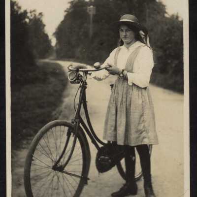Postcard - Young woman with bike