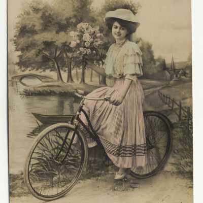 Postcard - Woman with bike "Une Pensée"