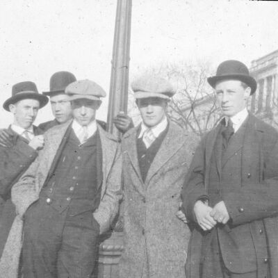 Five men posing at a lamppost