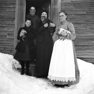 Group of people with cat and hens
