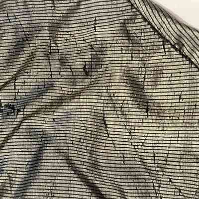 Areas of fabric failure on the back of the bodice.