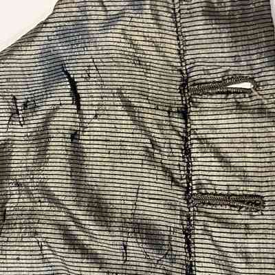 Areas of fabric failure on the back of the bodice.