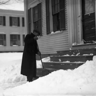 Charles E. Moody sweeping snow