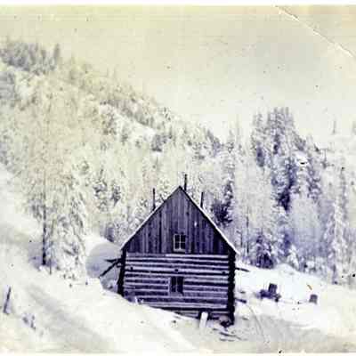 Snow Covered Log Cabin