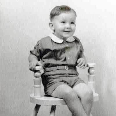 Unknown Young Boy On a Wooden Chair