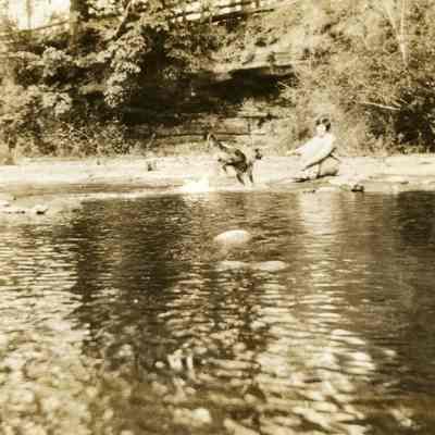 Barnett Album - Mercy Morehouse and dog "Sunny Jim" beside Milk Creek