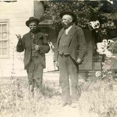 Two Unidentified Men Standing in Front of House - Talbert Collection