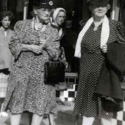 Unknown Older Women on Sidewalk in Front of a Store