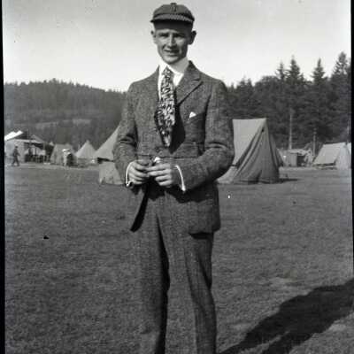 Man Standing in Front of Tents.