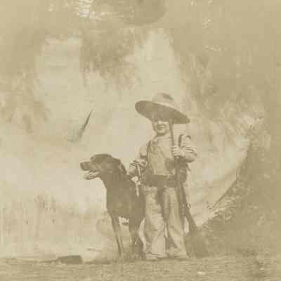 Unknown Child Dressed as a Cowboy with Gun and Dog