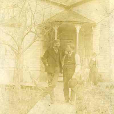 Alldridge Family - Two Men Standing in Front of a House