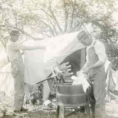 Two Men Washing Clothes at Camp Site