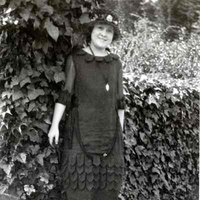Unknown Woman Standing by a Hedge
