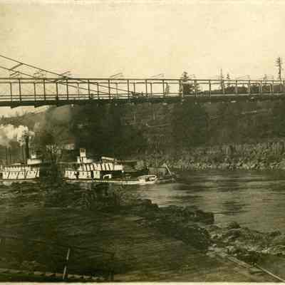 Two Steamboats Under Suspension Bridge in Oregon City.