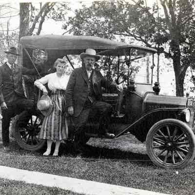 Two Couples Standing Next to a Model A Roadster