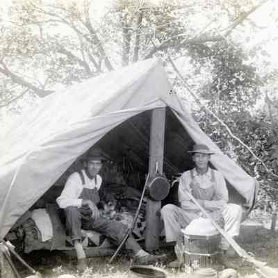 Two Men Sitting in a Camping Tent