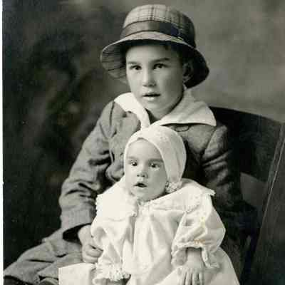 Alldridge Family - Young Man with hat holding a baby