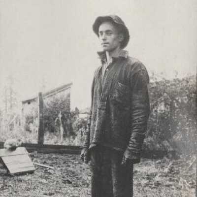Man in work clothes with chicken coop in background - Print, photographic 1913-1915