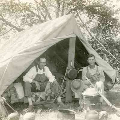 Two Men Sitting in a Camping Tent