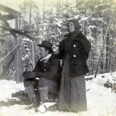 Unknown Man and Woman in Winter Clothes - Snow on the Ground