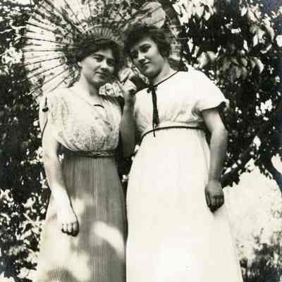 Two Unknown Women and Baby Posing under an Umbrella