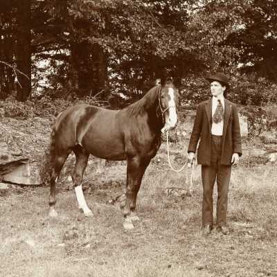 Man poses with Horse