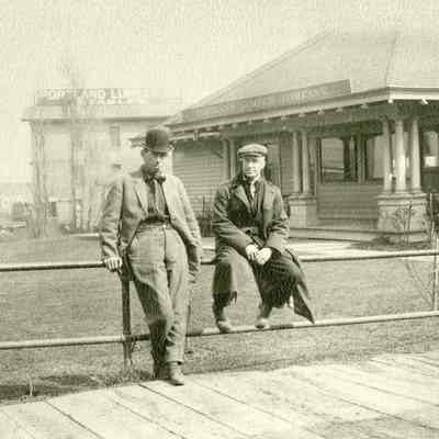 Unknown Men Sitting on a Railing in Front of Portland Lumber Company