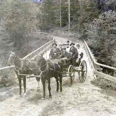 Burns Family Collection – Unknown Group in Horse Drawn Wagon on Bridge