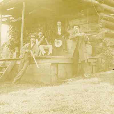 Five Unknown Men with Guns on the Porch of a Log Cabin