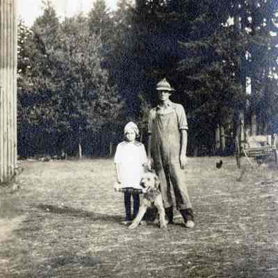 Unknown Farmer, Young Girl and Dog by Barn