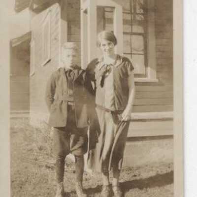 Boy and Young Woman by a House
