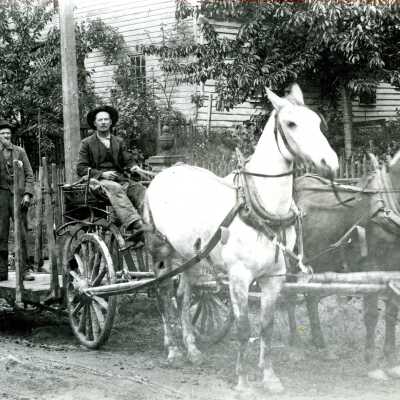 Two Men on Wagon Pulled by Two-horse Team