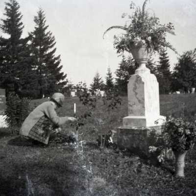 Woman with flowers at Mt. View Cemetery.