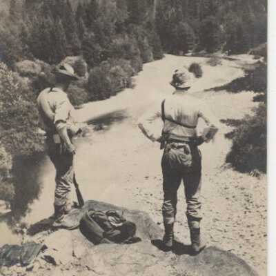Two men looking at the river