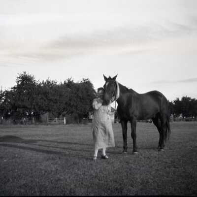 Woman with Horse in Field.