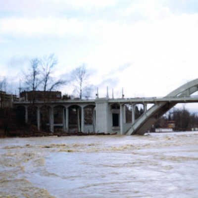 1964 Flood - West Linn from Oregon City with Log Drift against Arch Bridge.