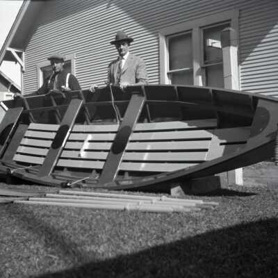 William Krueger and H.C. Frisbie with Rowboat in Yard. Photo #2.