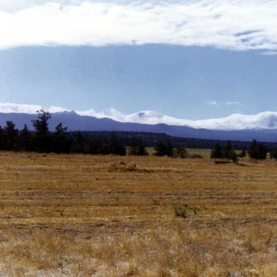 View across field toward mountains, 1970.