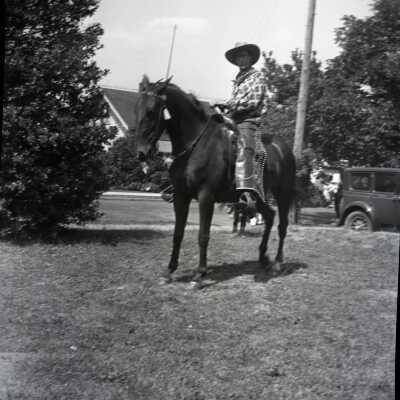 Man in Chaps on Horseback.
