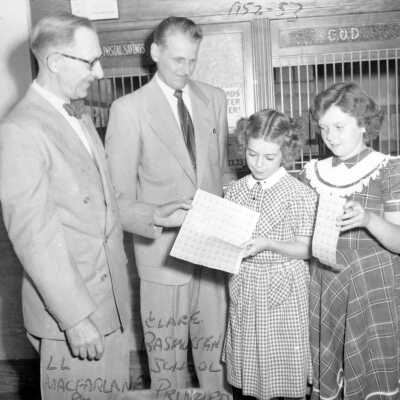 Postmaster and principal at post office with students