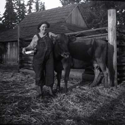 Woman in Overalls with Cow.